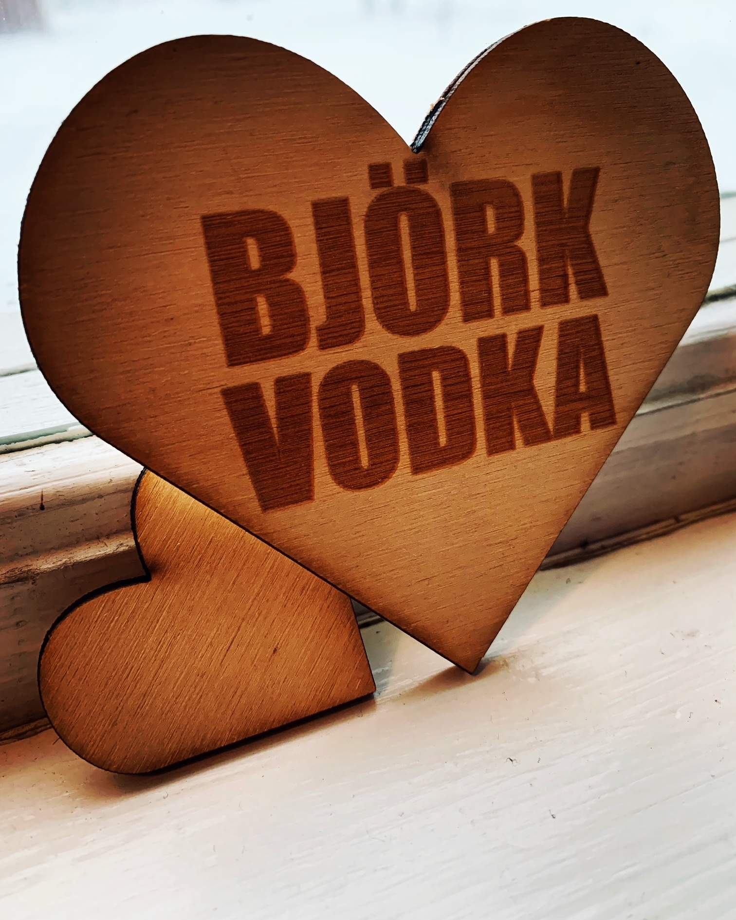 Hjärtformat drinkunderlägg i björkplywood med texten "Björkvodka" lasergraverad